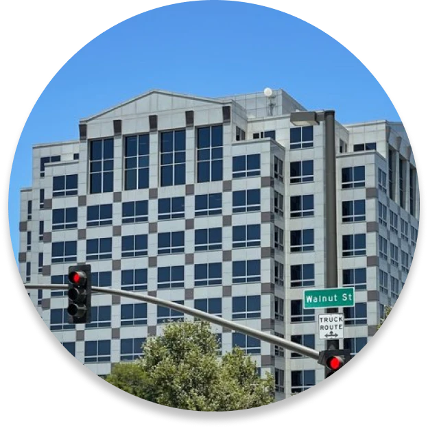 A small circular photo of a tall building on Walnut Street