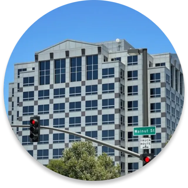 A small circular photo of a tall building on Walnut Street