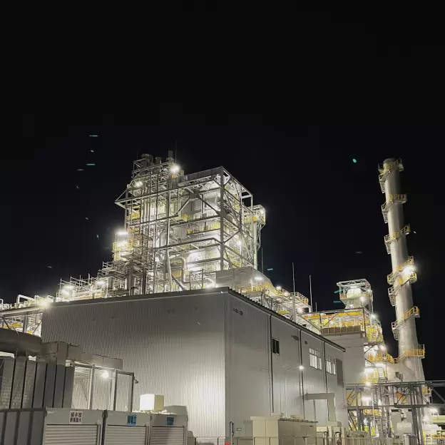 A nighttime photo of a biomass energy plant in Fukuyama